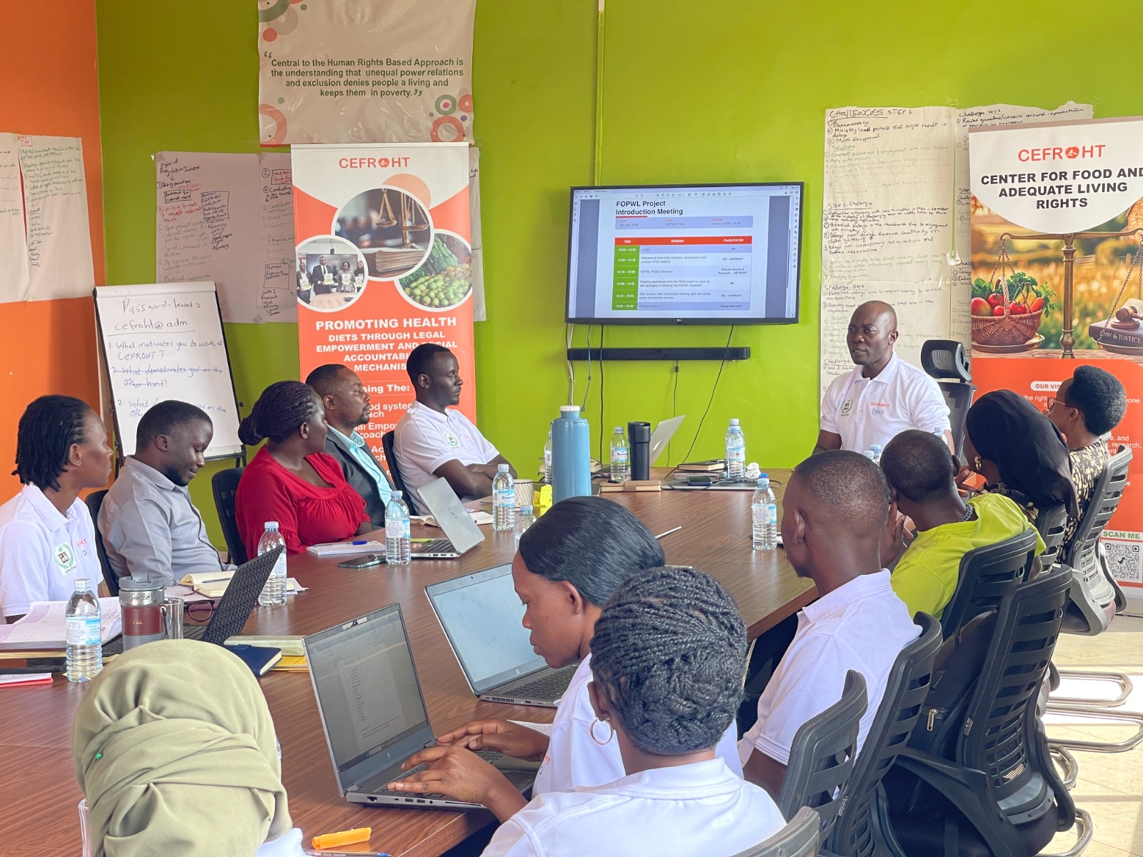 Coalition partners at a technical working session around a conference table, with advocacy materials displayed on the walls.